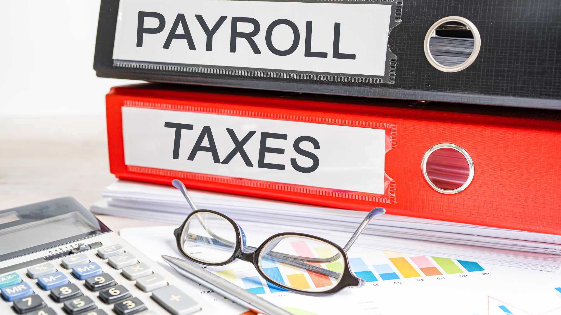 Payroll tax compliance concept showing payroll and tax folders with financial documents, calculator and glasses.
